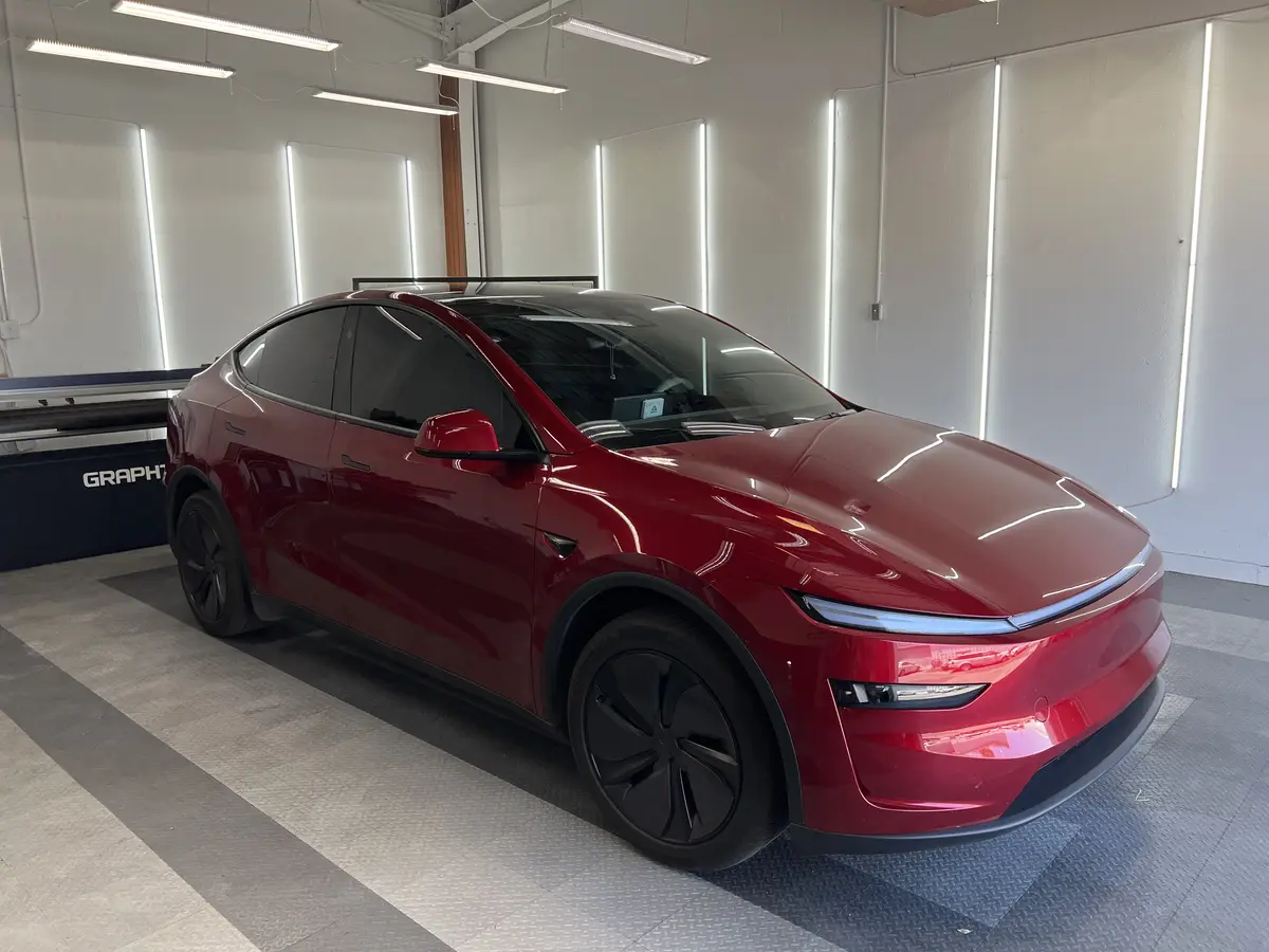 Red Tesla Model Y after Avery Dennison Encore Supreme ceramic window tint (view 1)