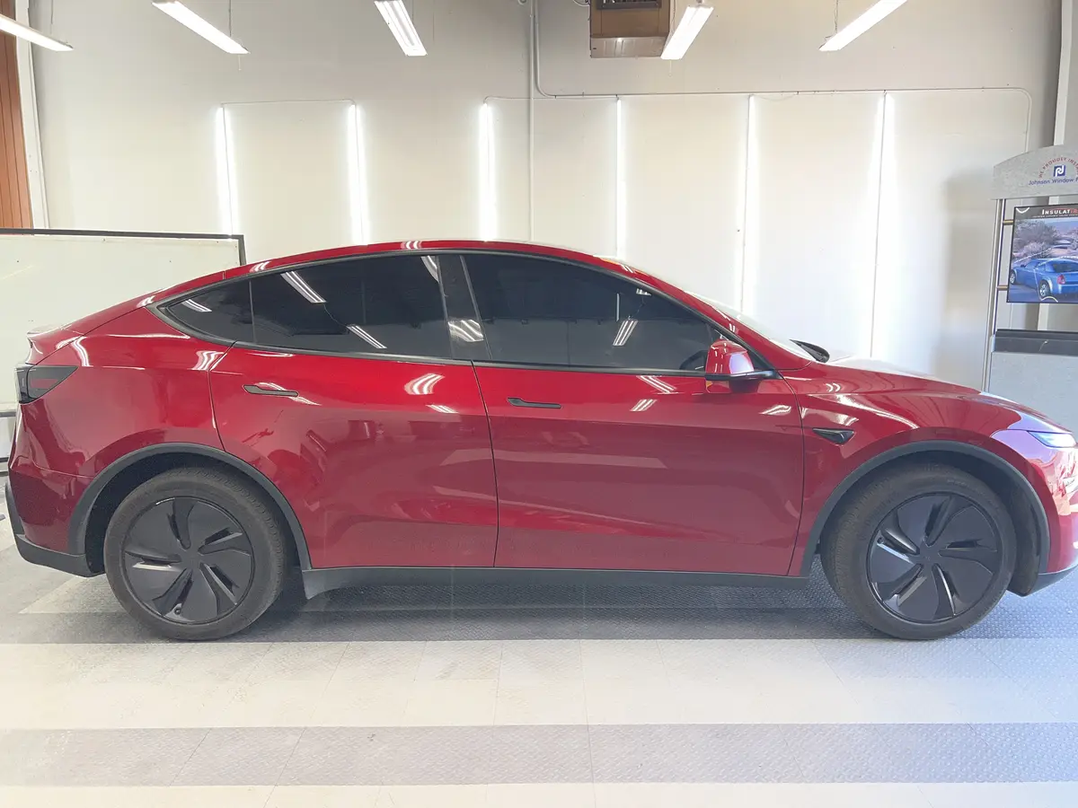 Red Tesla Model Y after Avery Dennison Encore Supreme ceramic window tint (view 2)