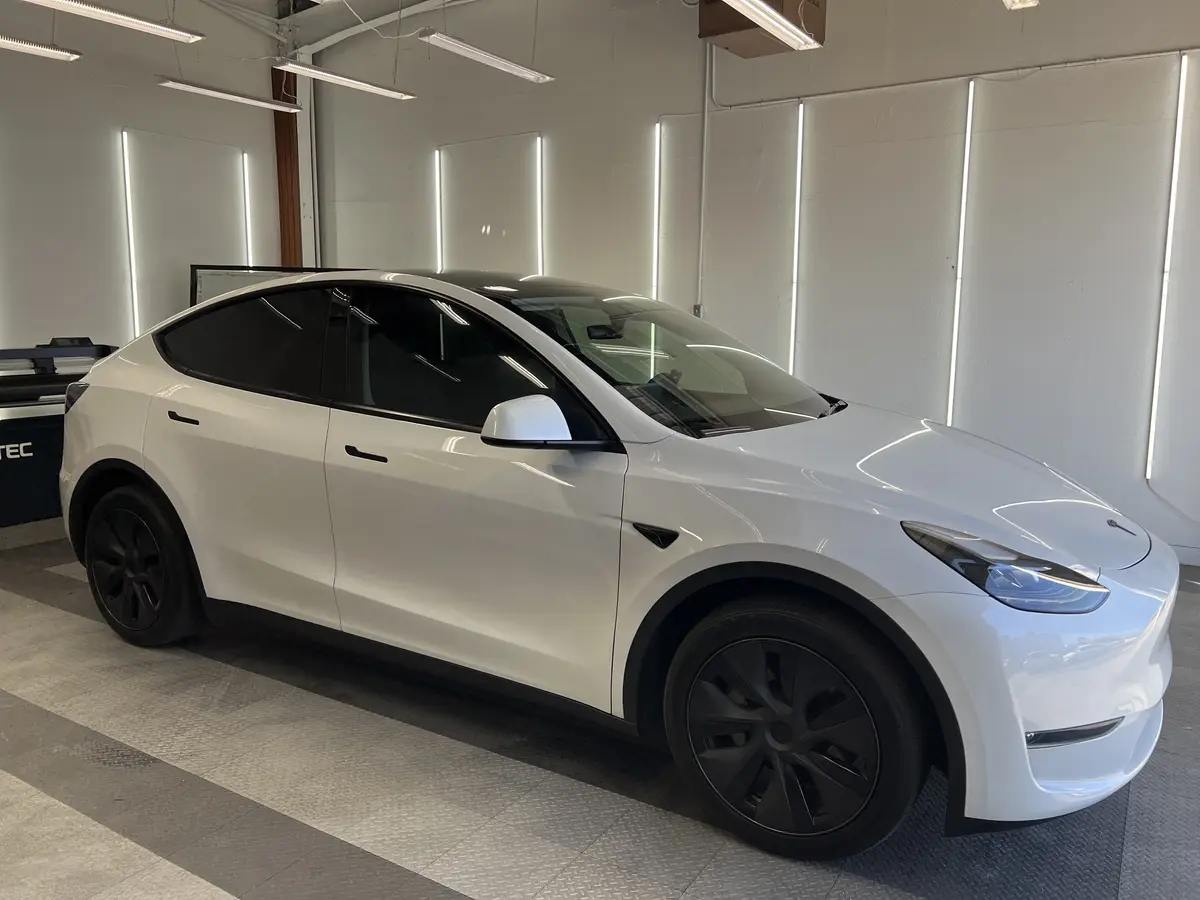 White Tesla Model Y after Avery Dennison Encore Supreme ceramic window tint (view 1)