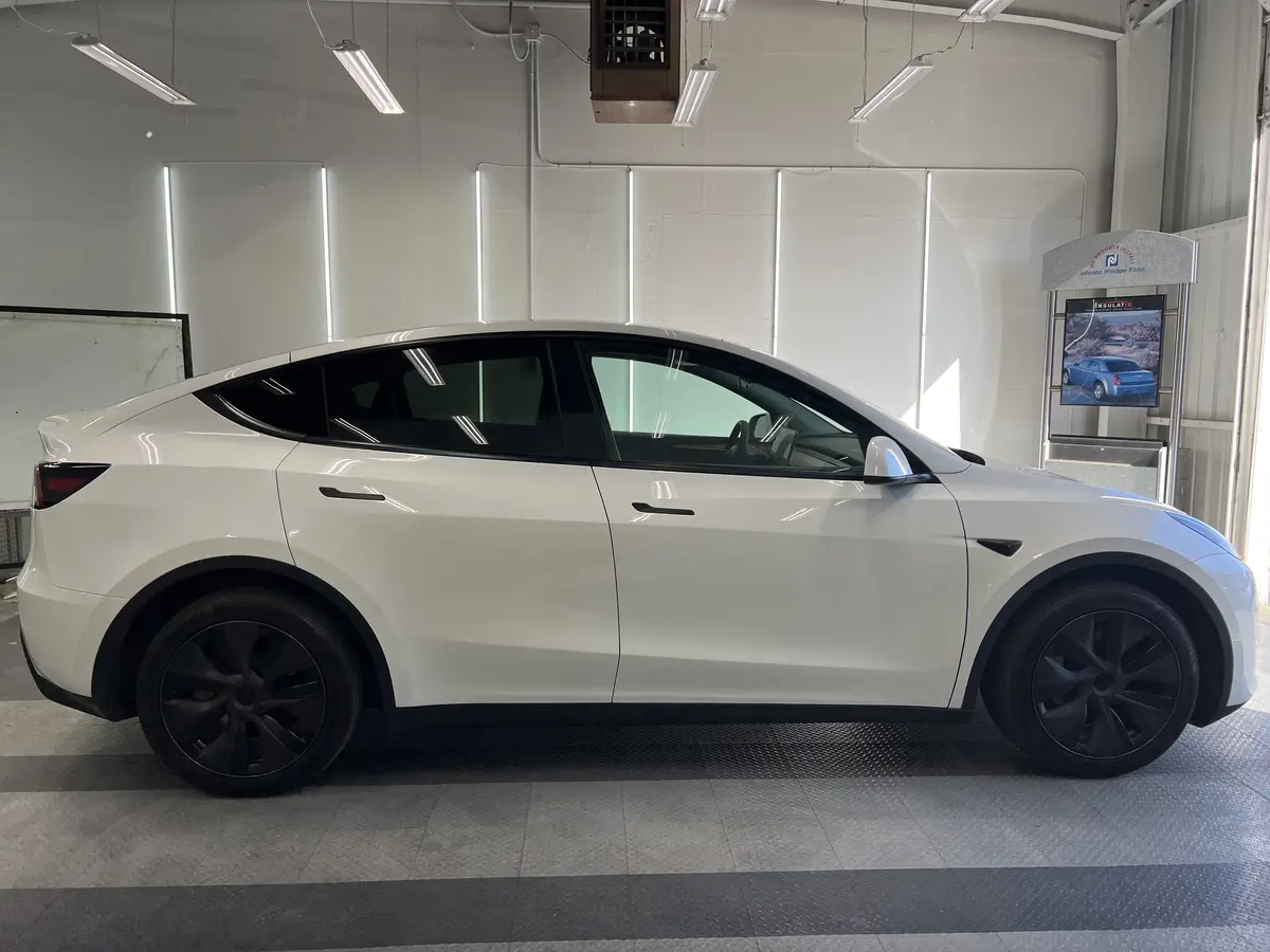 White Tesla Model Y before window tinting, factory glass (view 2)