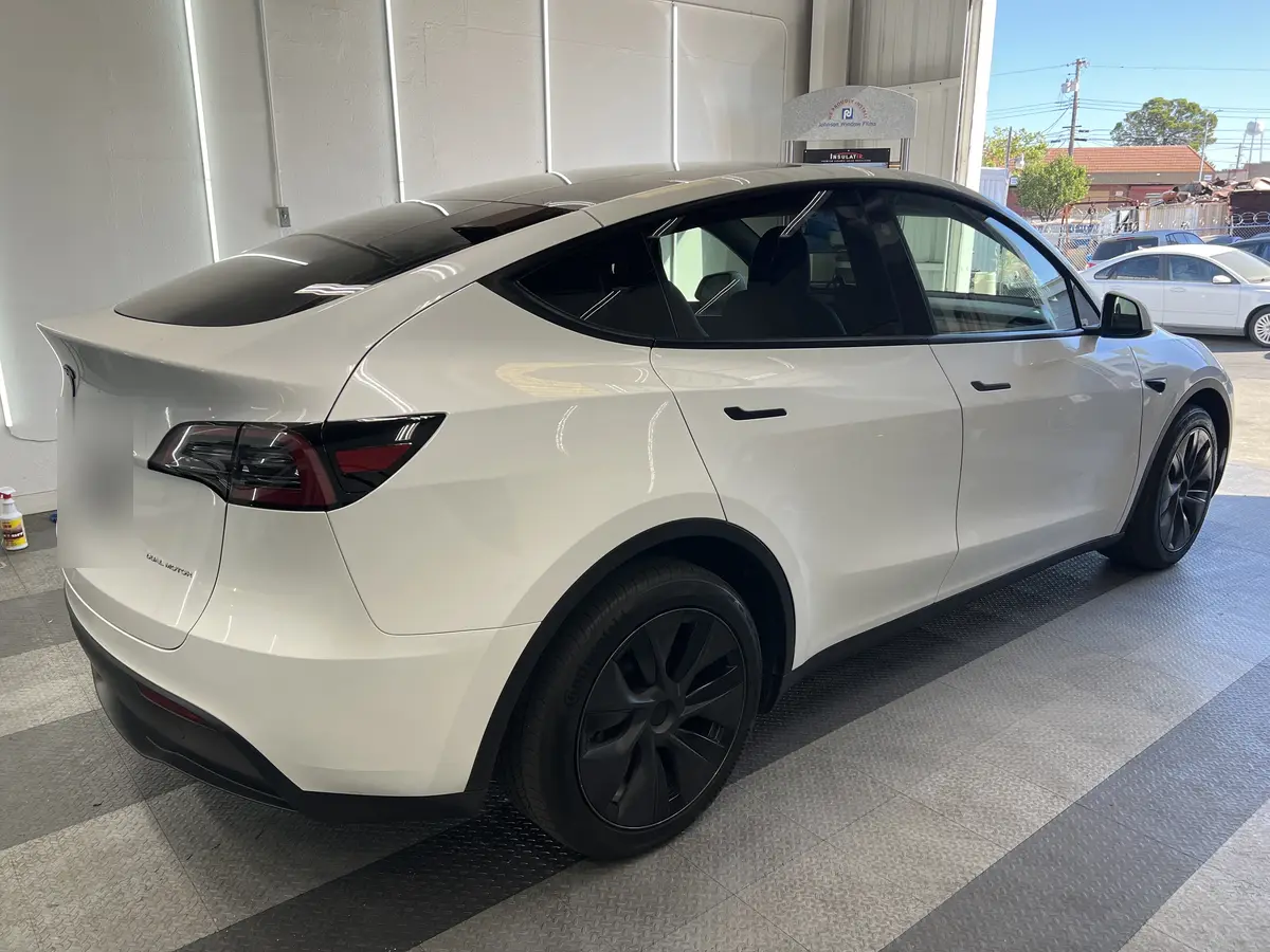 White Tesla Model Y before window tinting, factory glass (view 3)