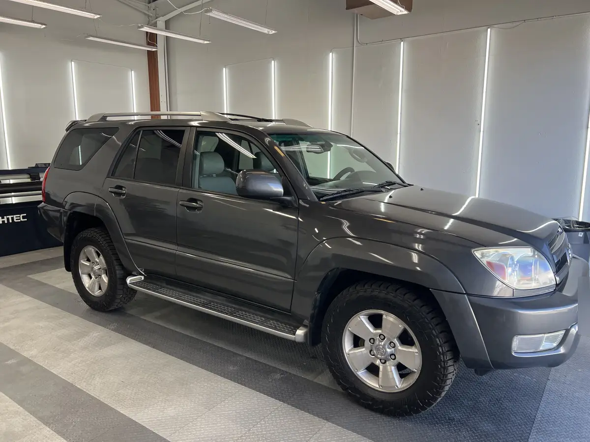 Gray Toyota 4Runner before window tinting, factory glass (view 1)