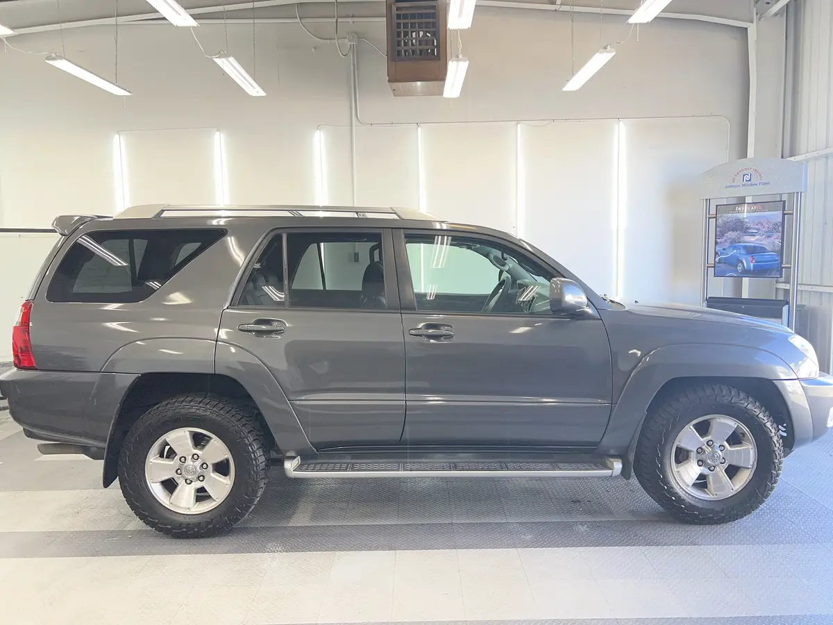 Gray Toyota 4Runner before window tinting, factory glass (view 2)