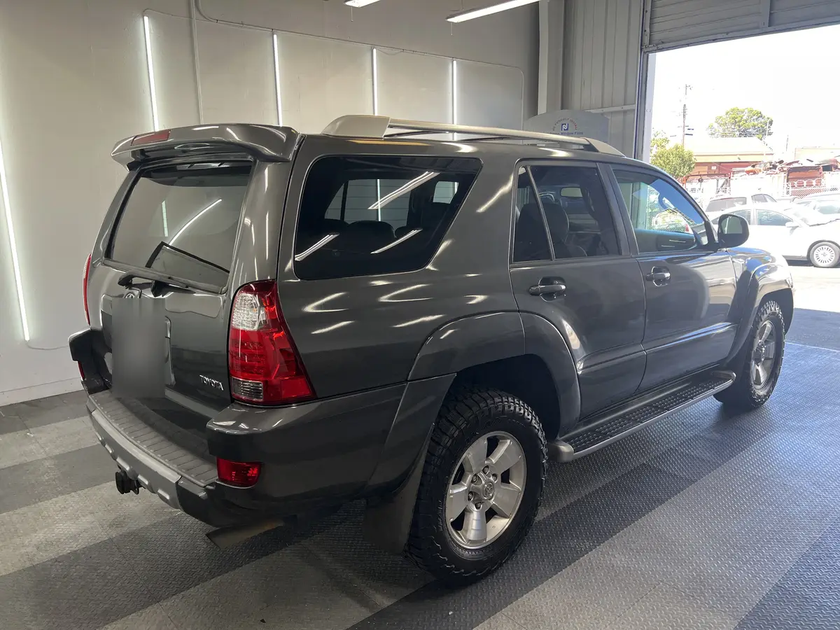 Gray Toyota 4Runner before window tinting, factory glass (view 3)