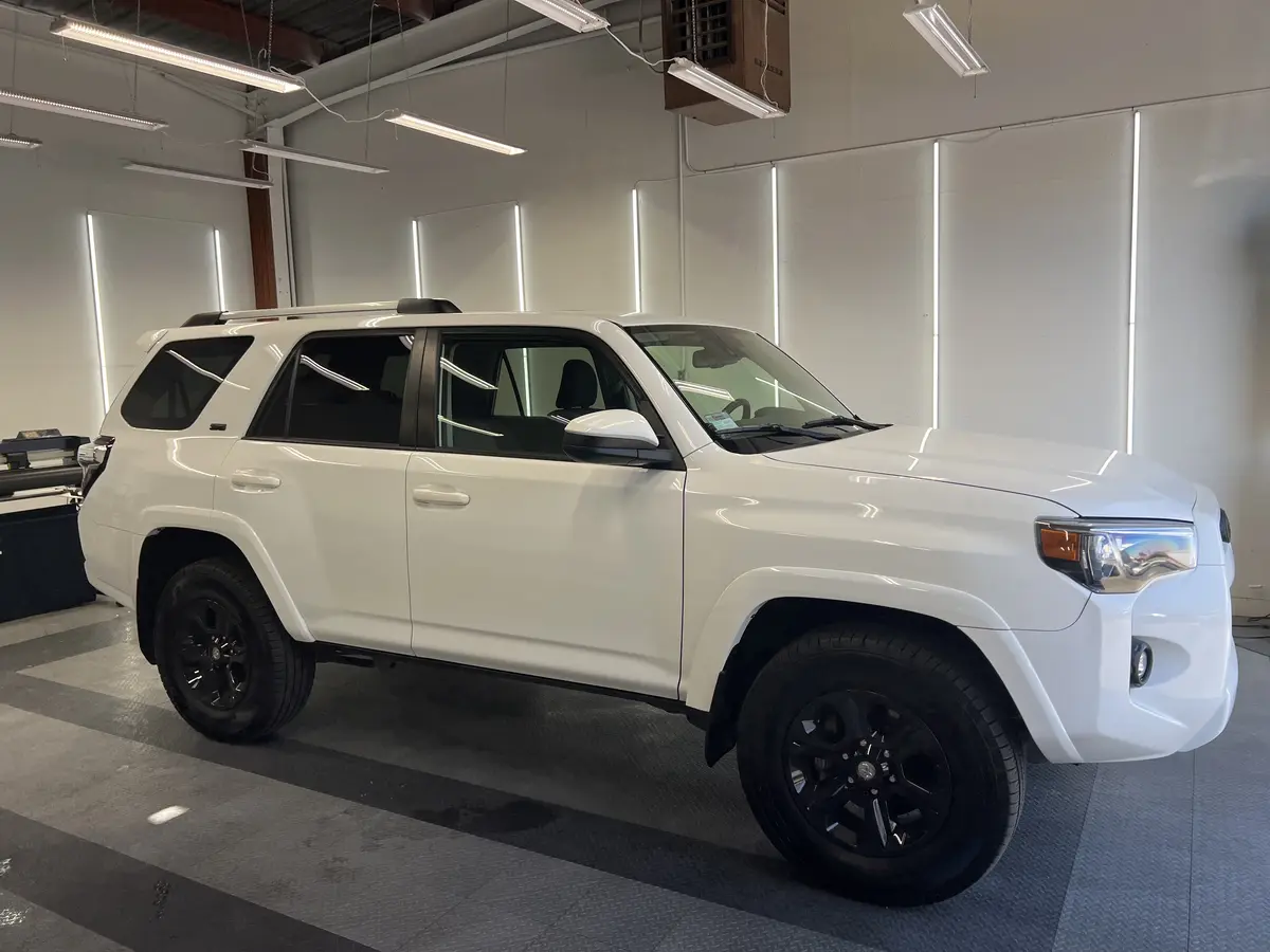 White Toyota 4Runner before window tinting, factory glass (view 2)