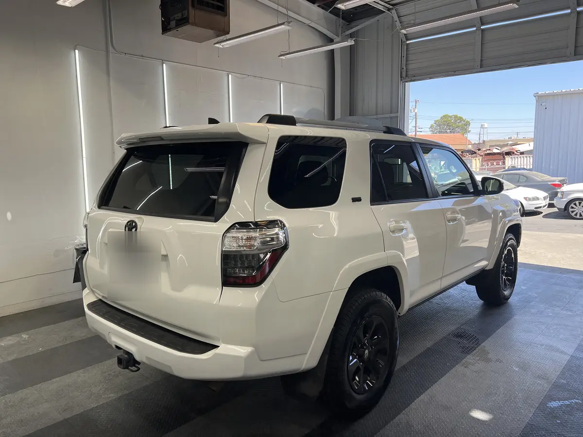 White Toyota 4Runner before window tinting, factory glass (view 3)