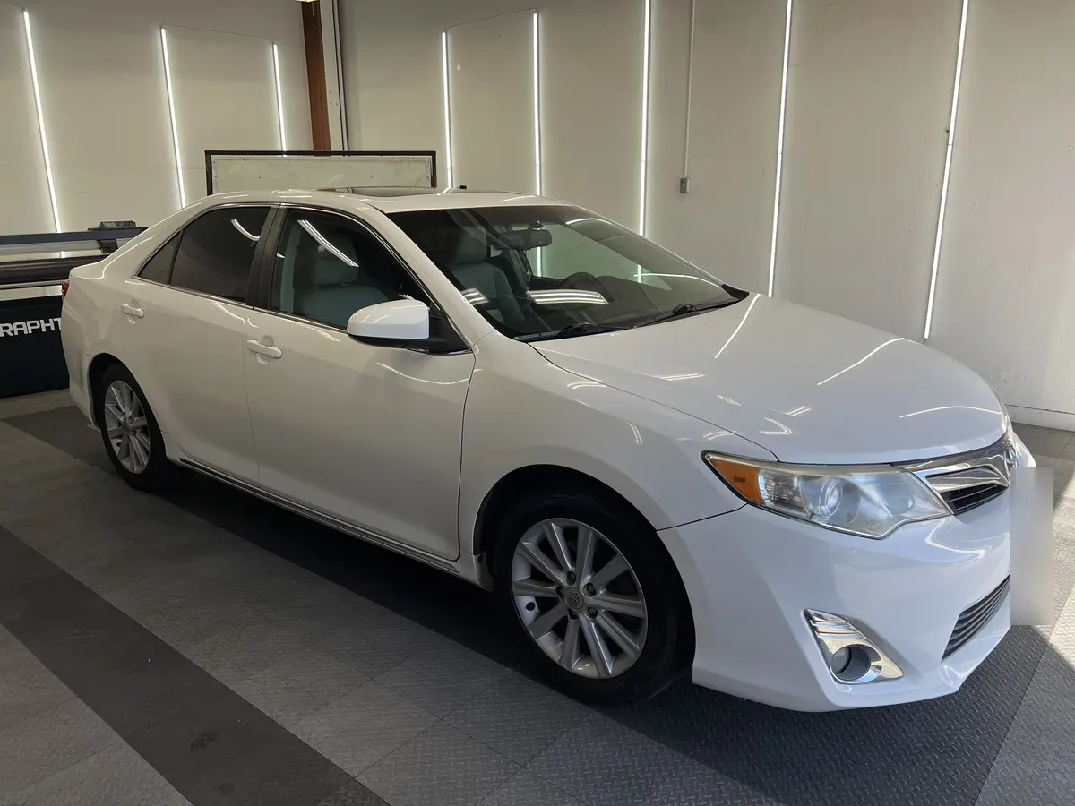 White Toyota Camry before window tinting, factory glass (view 1)