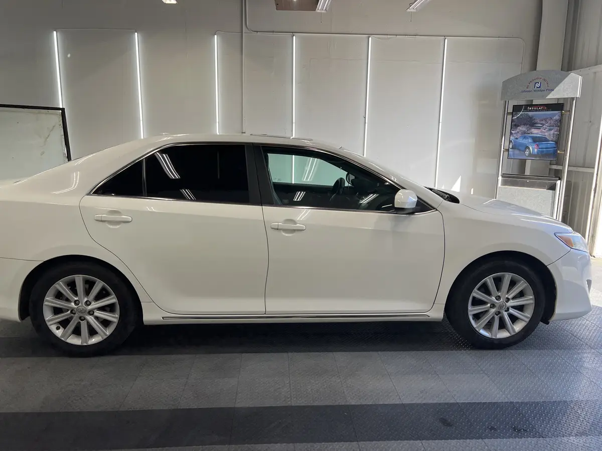 White Toyota Camry before window tinting, factory glass (view 2)