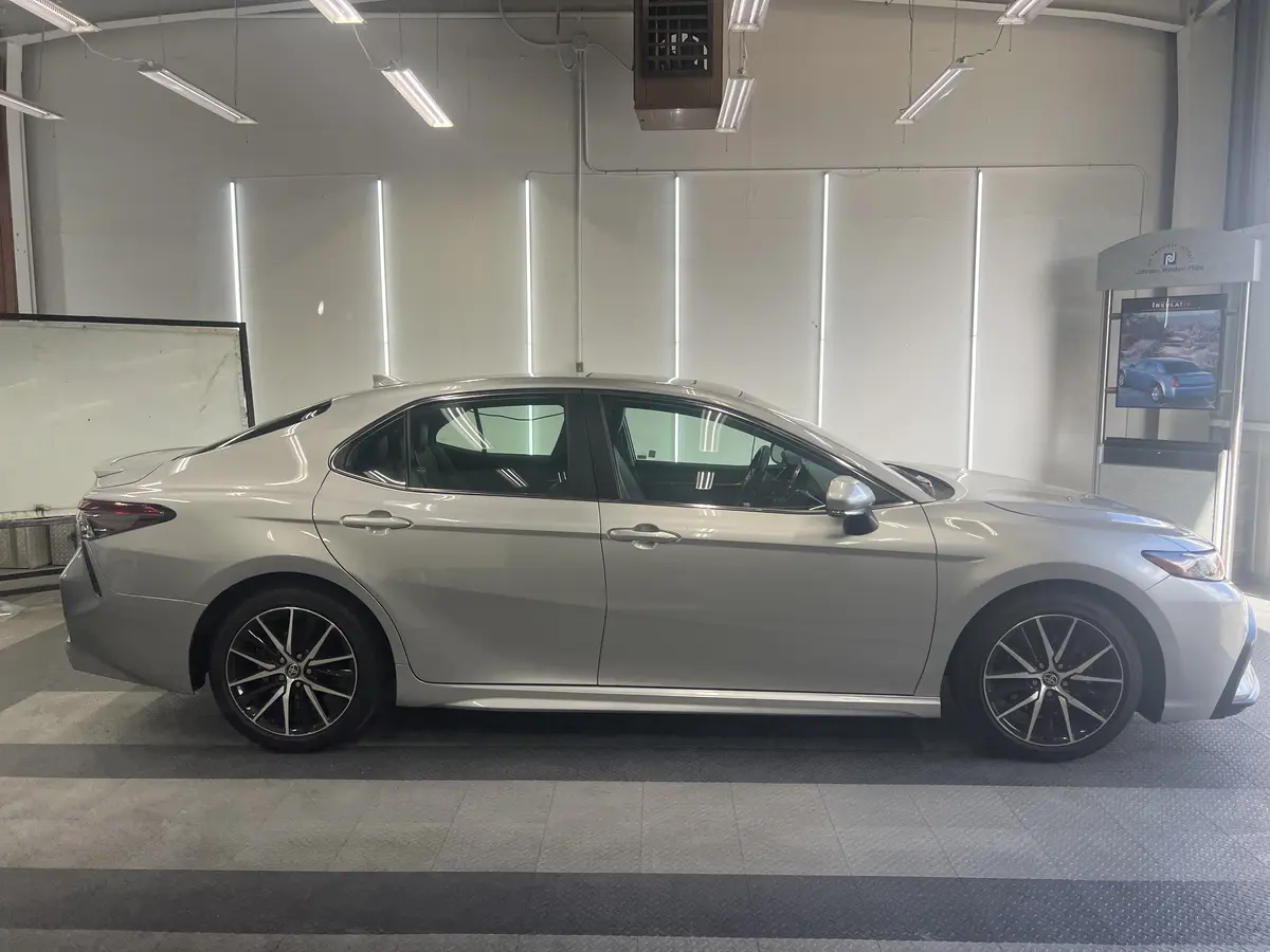 Silver Toyota Camry before window tinting, factory glass (view 2)