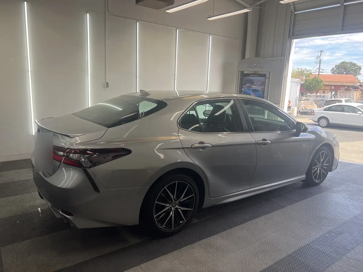 Silver Toyota Camry before window tinting, factory glass (view 3)