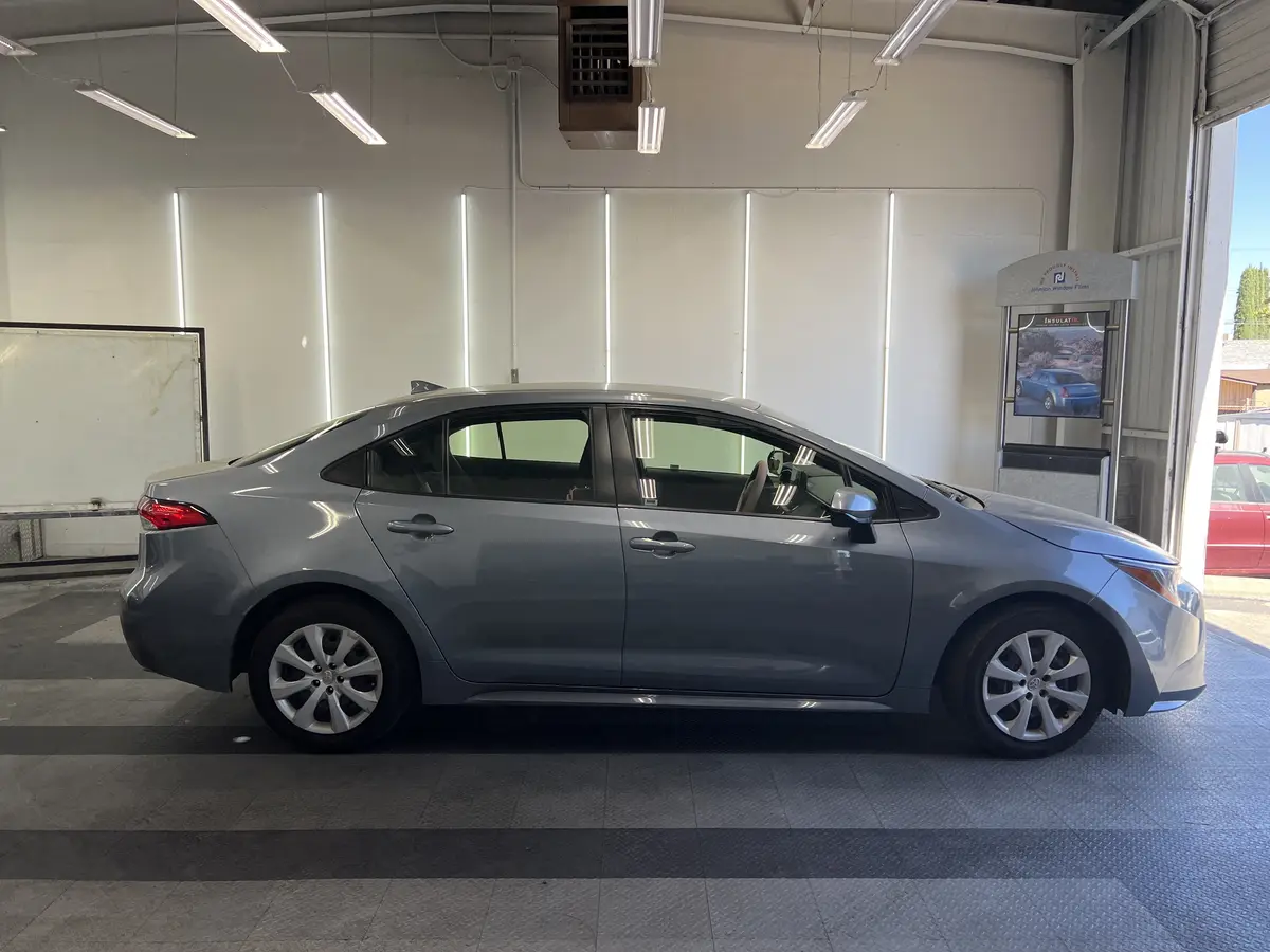 Gray Toyota Corolla before window tinting, factory glass (view 2)
