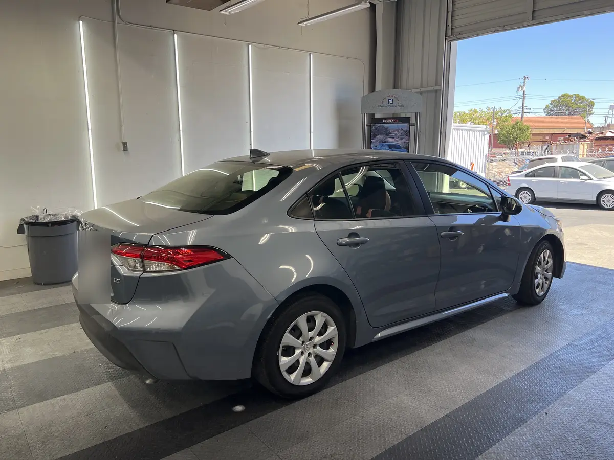 Gray Toyota Corolla before window tinting, factory glass (view 3)