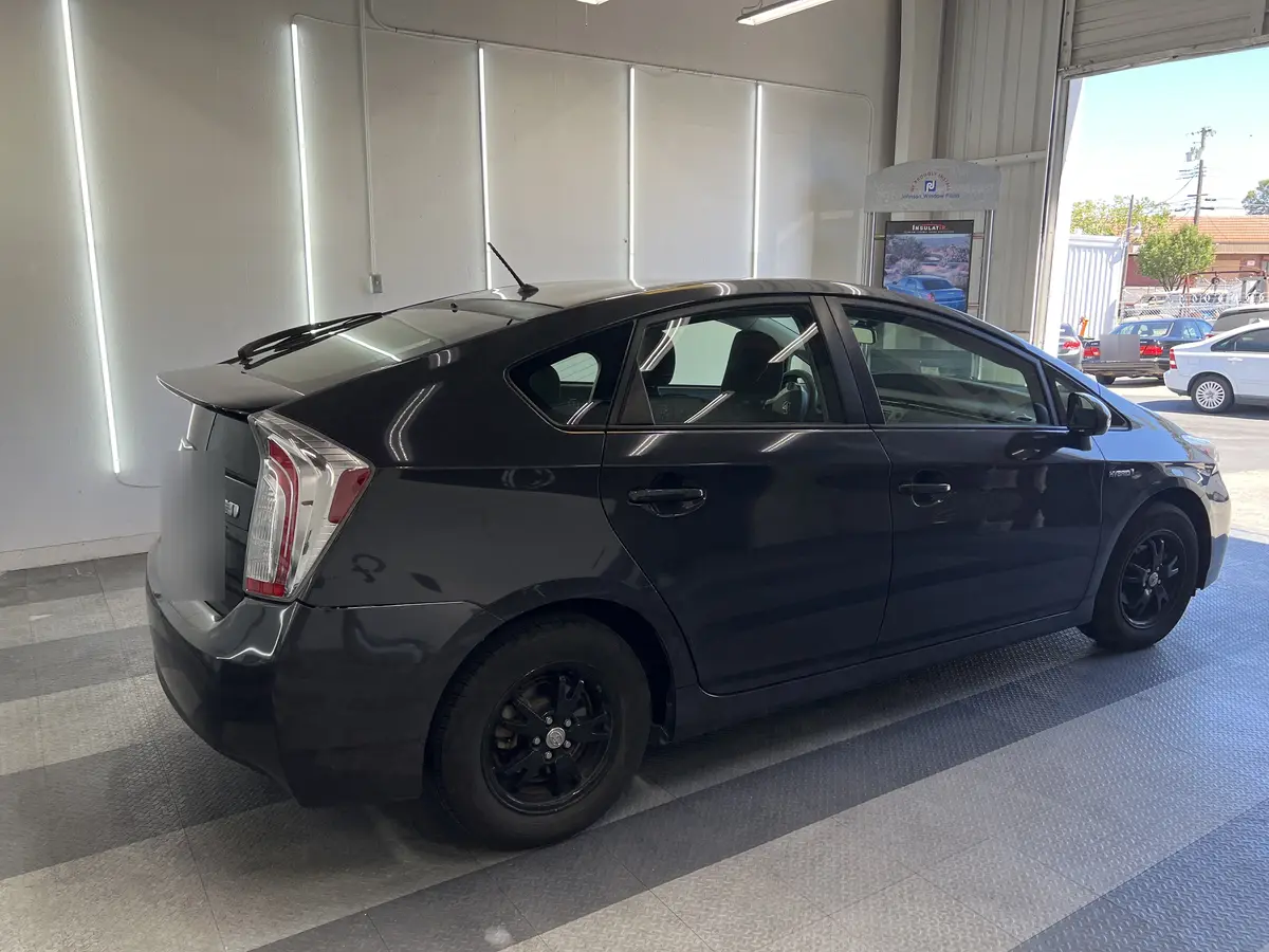 Gray Toyota Prius before window tinting, factory glass (view 3)