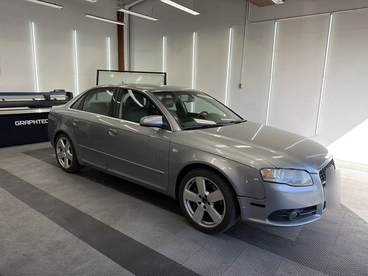 Silver Audi A4 before window tinting, factory glass (view 1)
