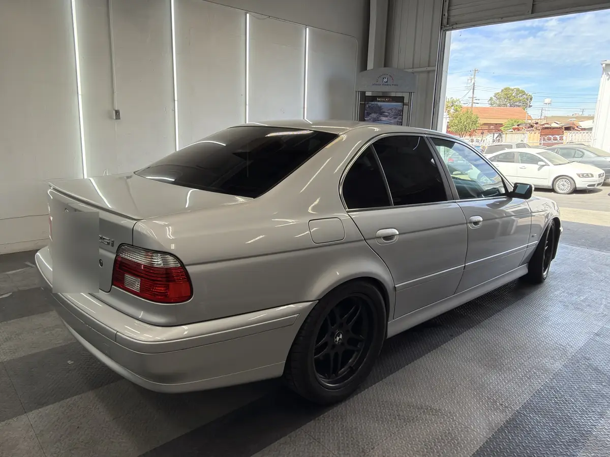 Silver BMW 5 Series after Avery Dennison Encore Supreme ceramic window tint (view 1)
