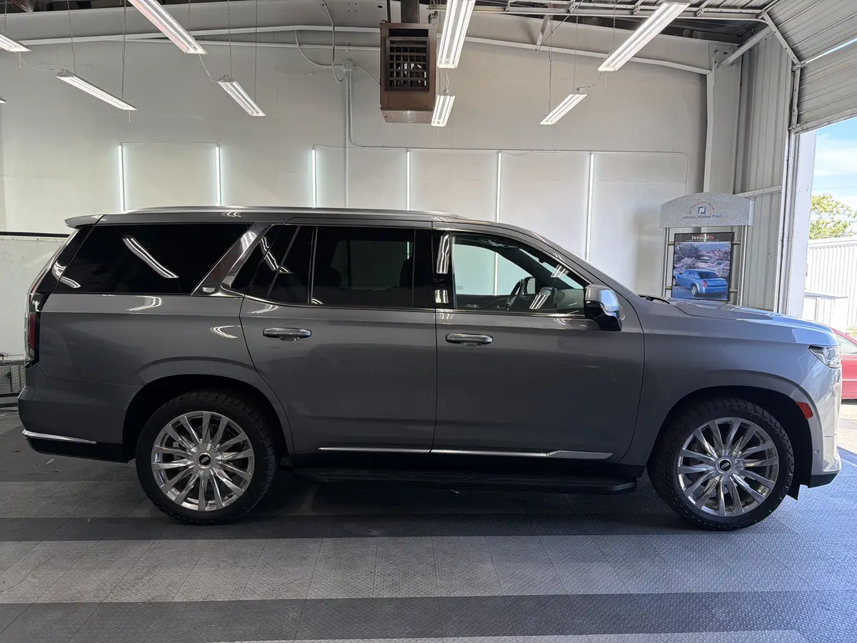 Gray Cadillac Escalade before window tinting, factory glass (view 2)