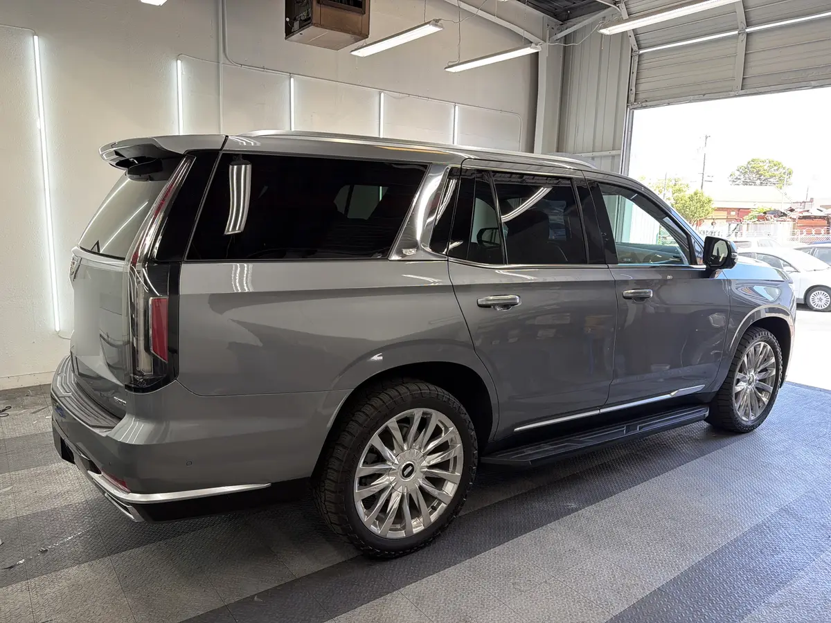 Gray Cadillac Escalade before window tinting, factory glass (view 3)