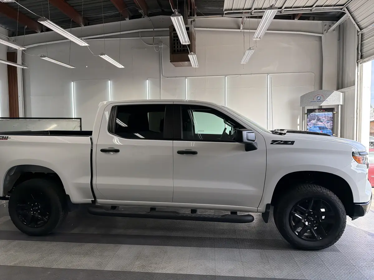 White Chevrolet Silverado before window tinting, factory glass (view 1)