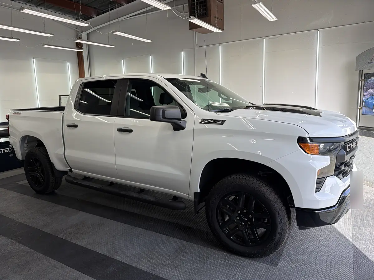 White Chevrolet Silverado before window tinting, factory glass (view 2)