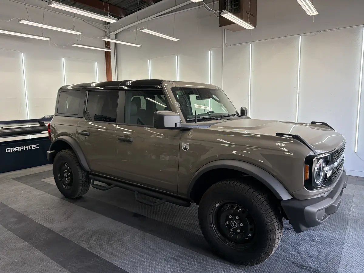 Gray Ford Bronco before window tinting, factory glass (view 1)
