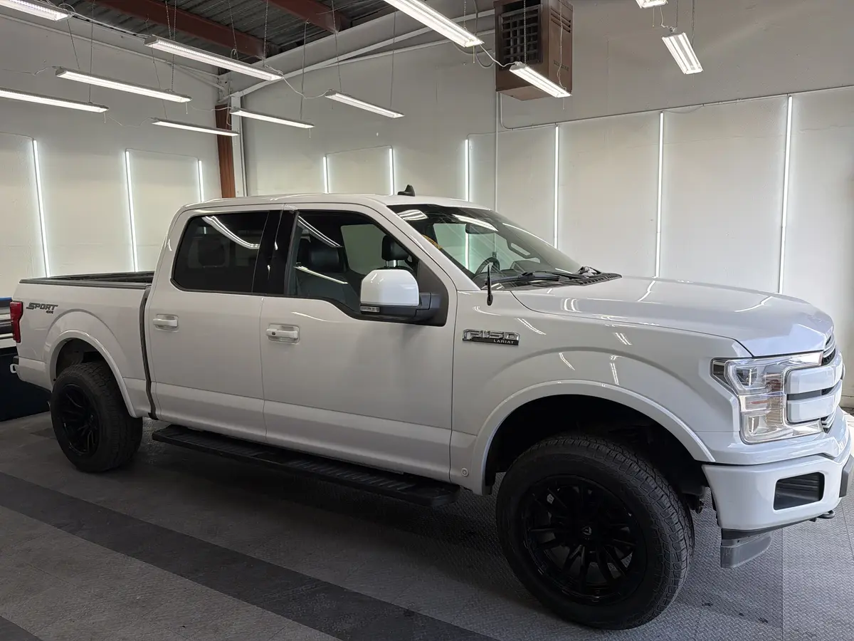 Silver Ford F-150 before window tinting, factory glass (view 1)