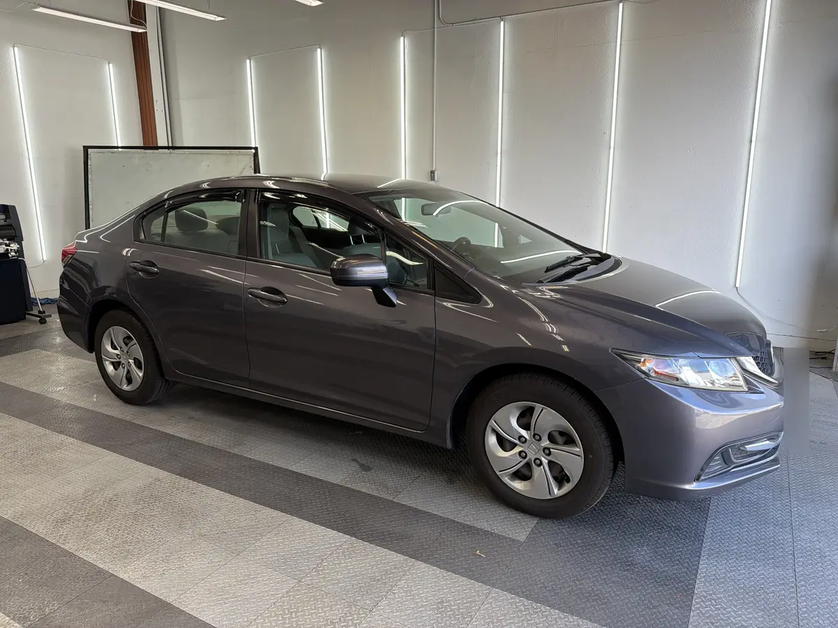 Gray Honda Civic before window tinting, factory glass (view 1)