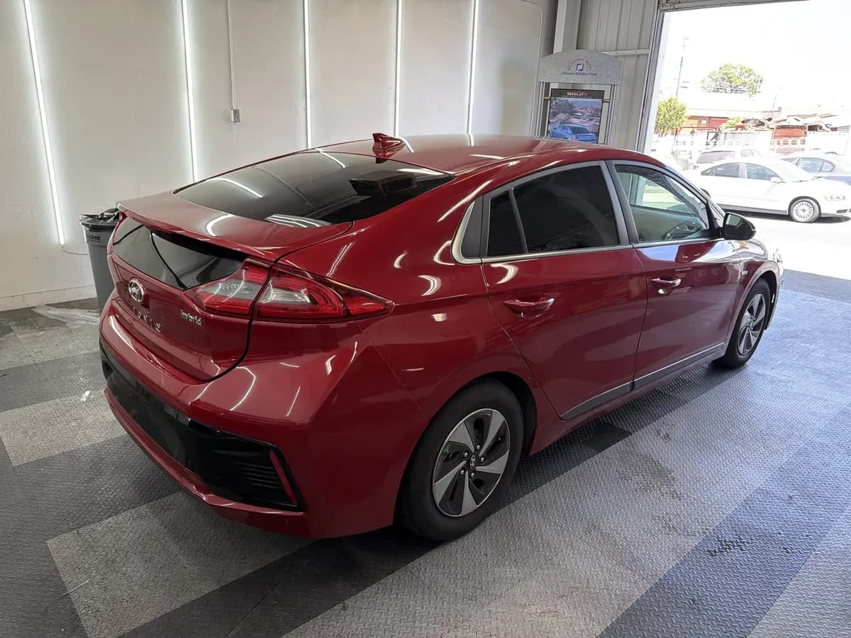 Red Hyundai Ioniq after Avery Dennison Encore Supreme ceramic window tint (view 2)