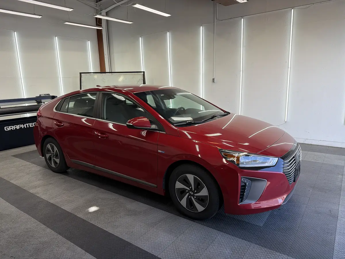 Red Hyundai Ioniq before window tinting, factory glass (view 1)
