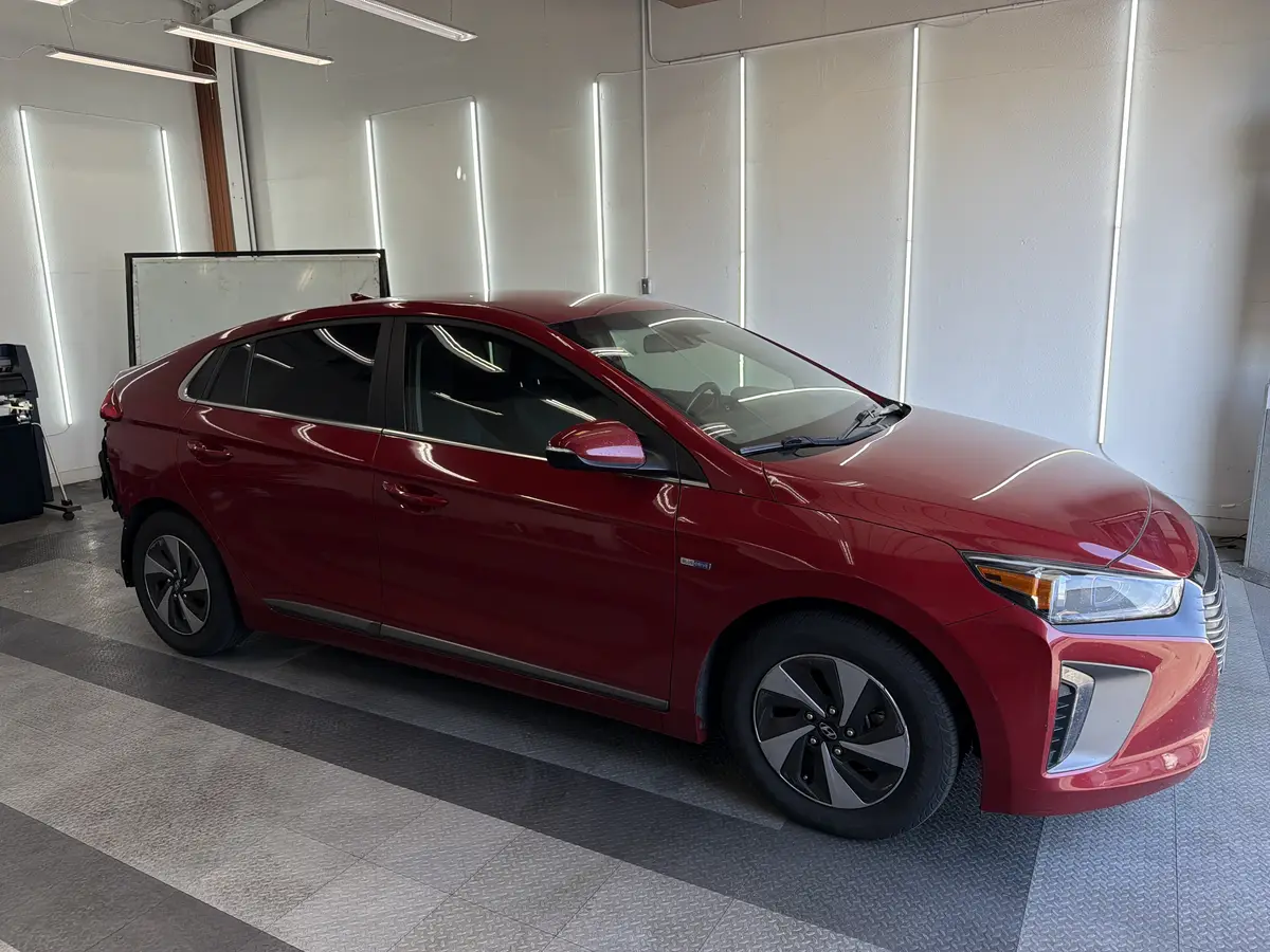Red Hyundai Ioniq at Quality Window Tinting, ceramic window tint job (photo 1)