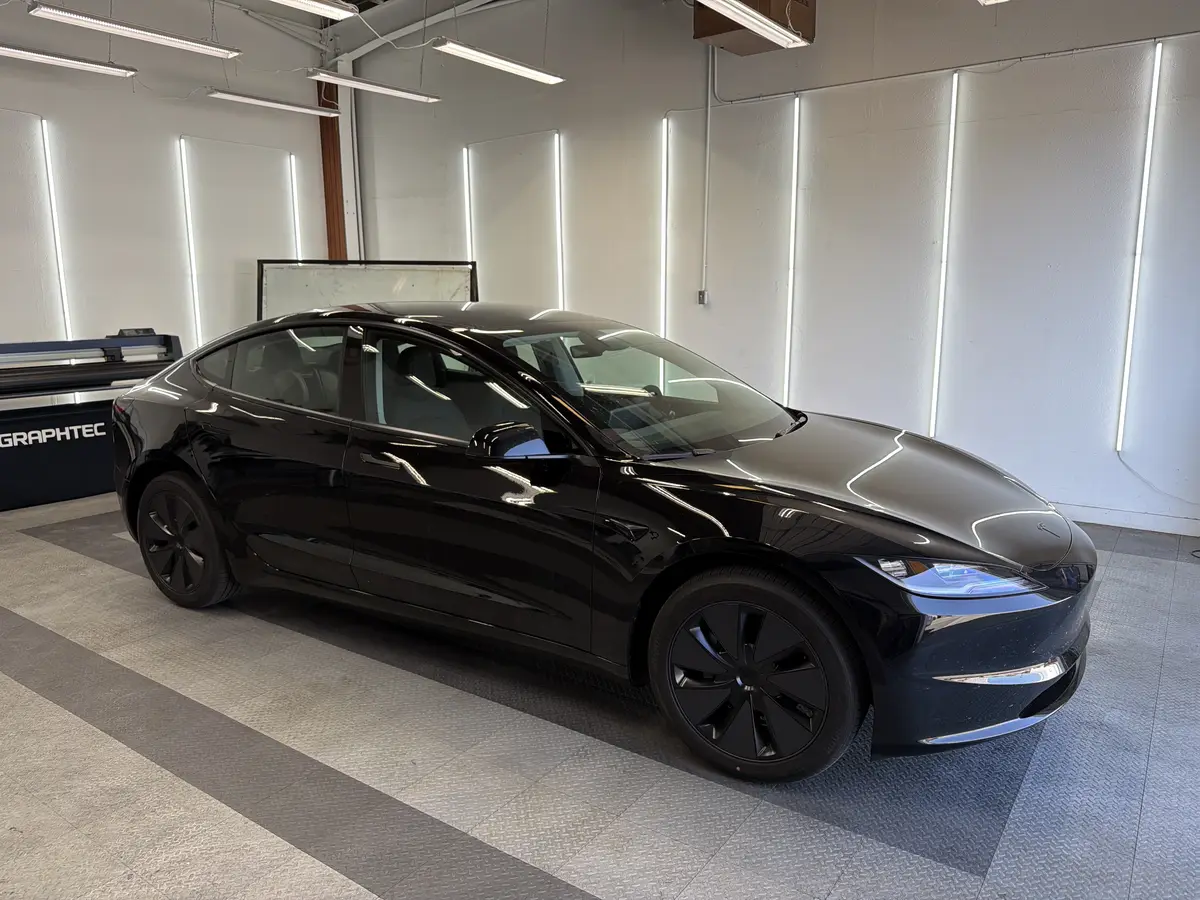 Black Tesla Model 3 before window tinting, factory glass (view 1)