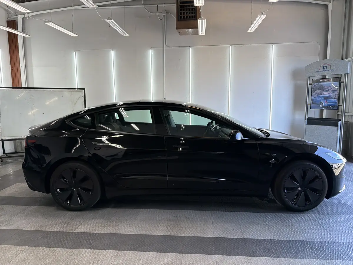 Black Tesla Model 3 before window tinting, factory glass (view 2)
