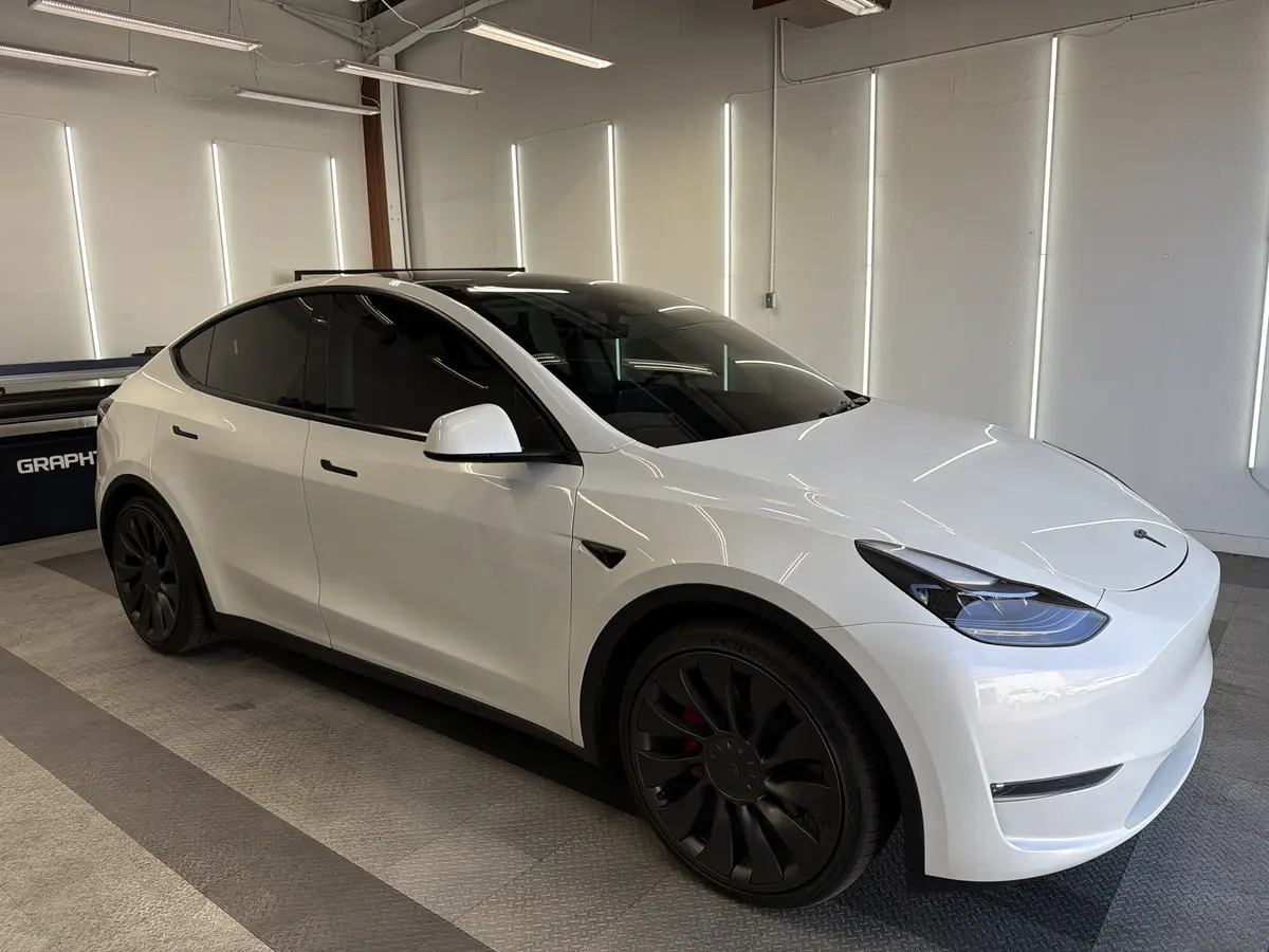 White Tesla Model Y after Avery Dennison Encore Supreme ceramic window tint (view 1)
