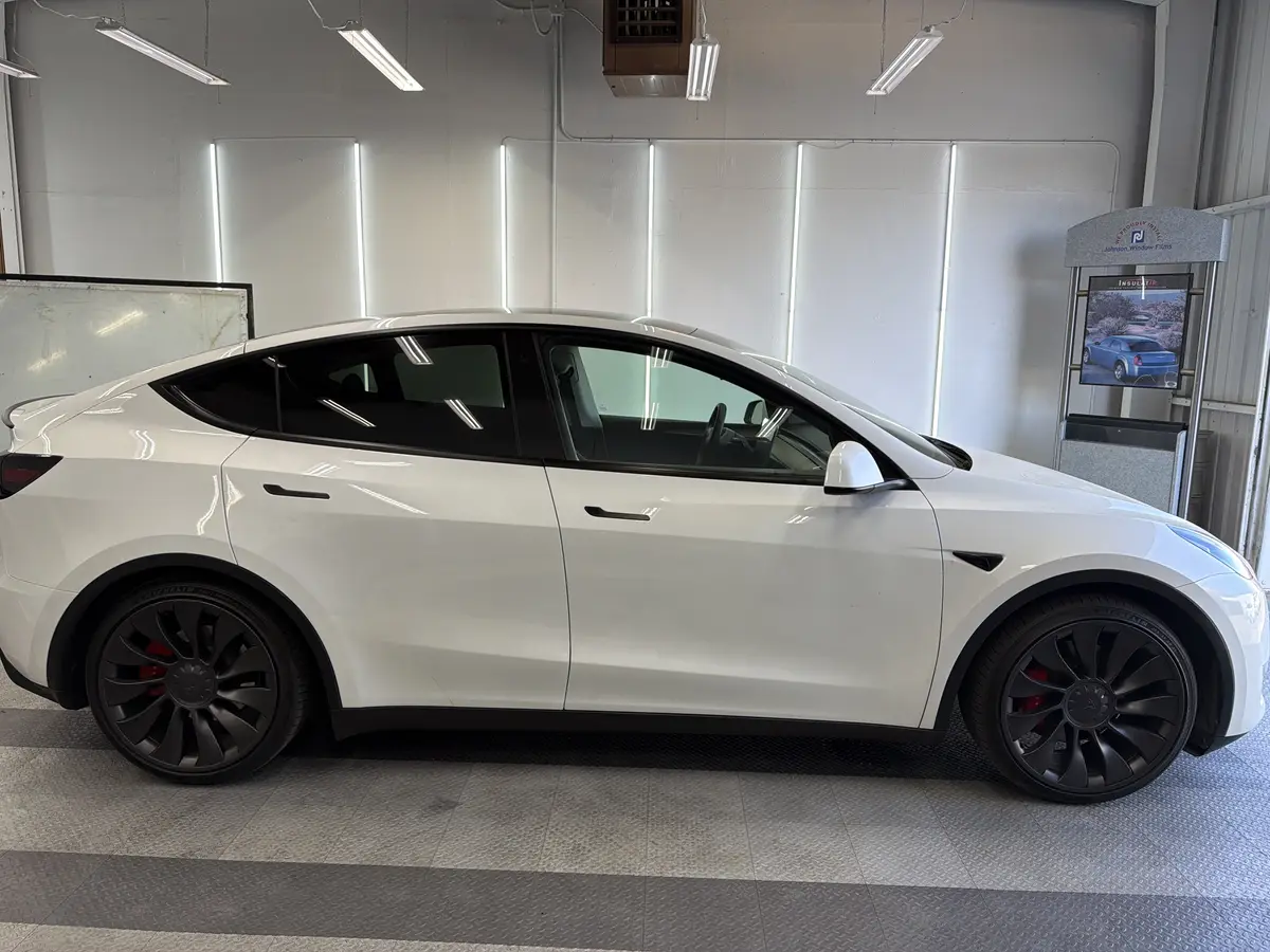 White Tesla Model Y before window tinting, factory glass (view 2)