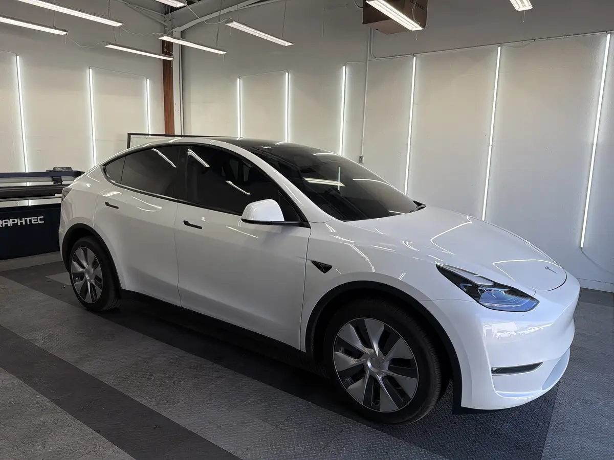 White Tesla Model Y after Avery Dennison Encore Supreme ceramic window tint (view 1)