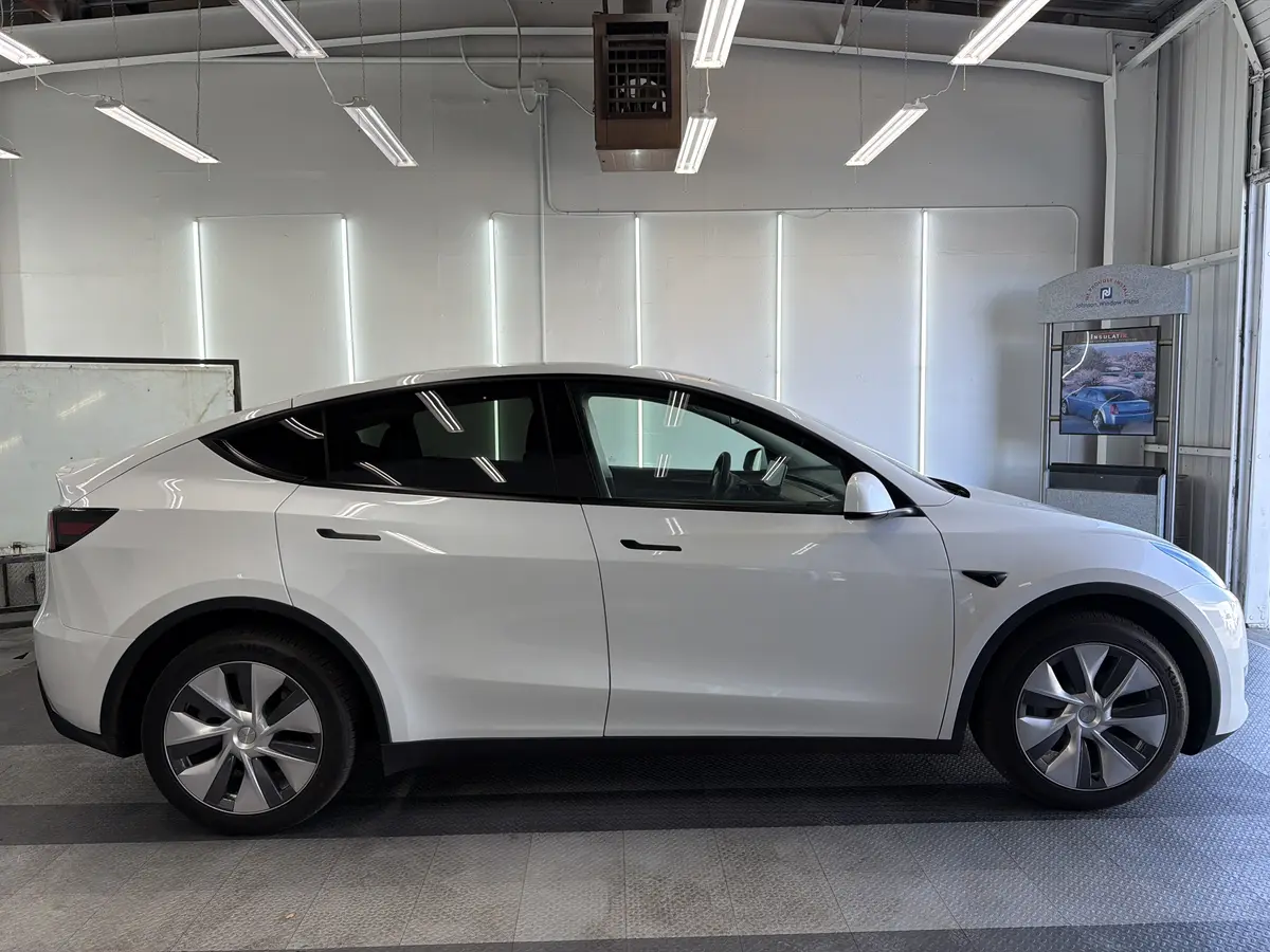 White Tesla Model Y before window tinting, factory glass (view 2)