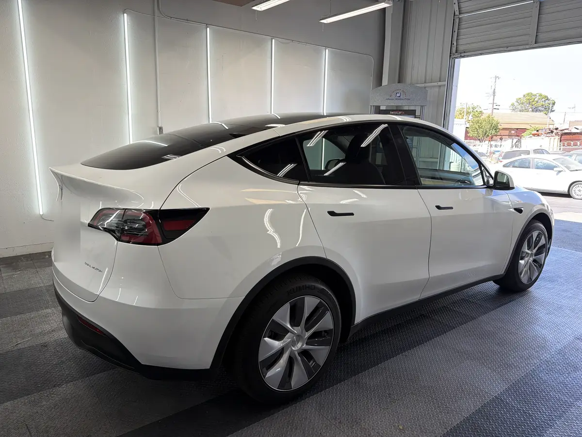 White Tesla Model Y before window tinting, factory glass (view 3)
