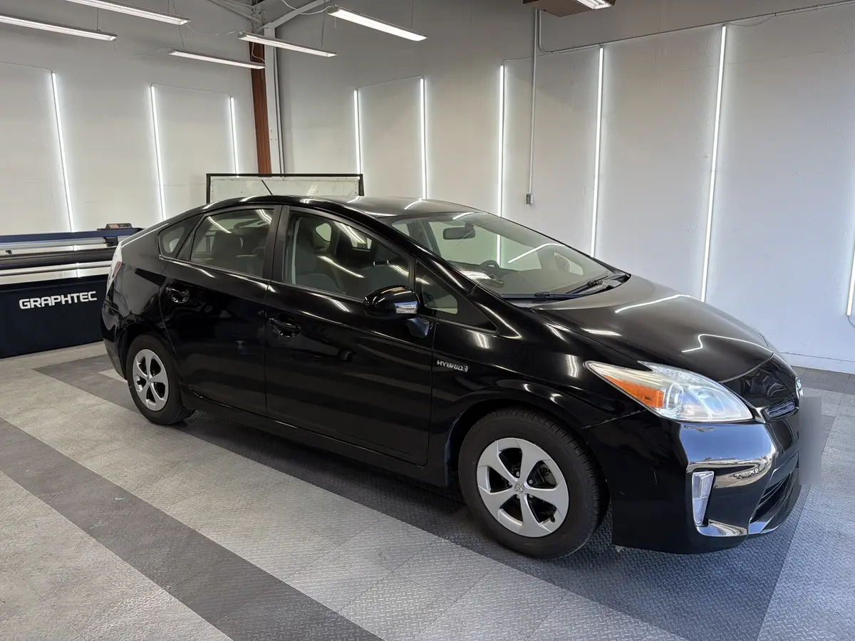 Black Toyota Prius before window tinting, factory glass (view 1)