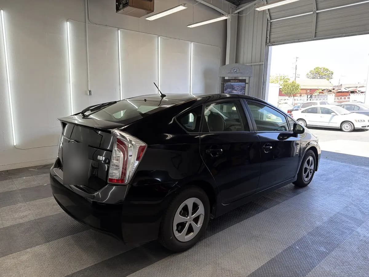 Black Toyota Prius before window tinting, factory glass (view 3)