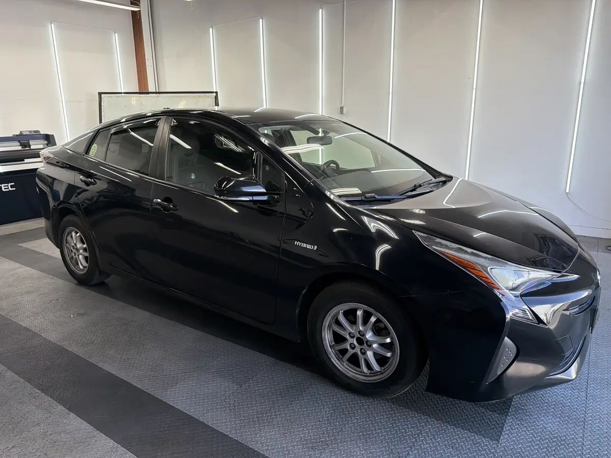 Black Toyota Prius before window tinting, factory glass (view 1)