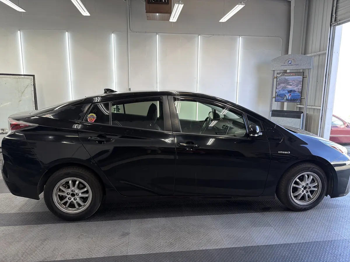 Black Toyota Prius before window tinting, factory glass (view 2)