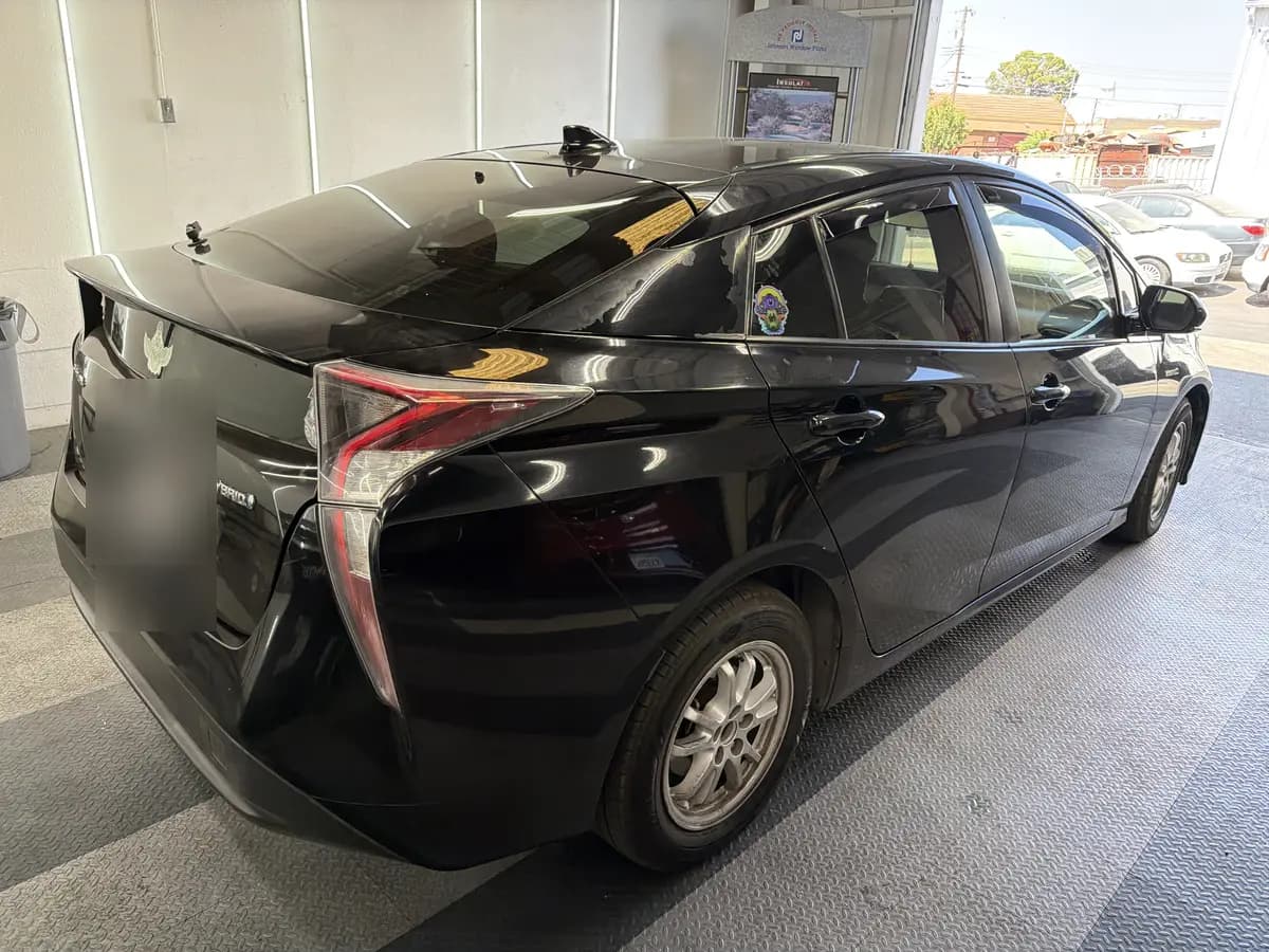 Black Toyota Prius before window tinting, factory glass (view 3)