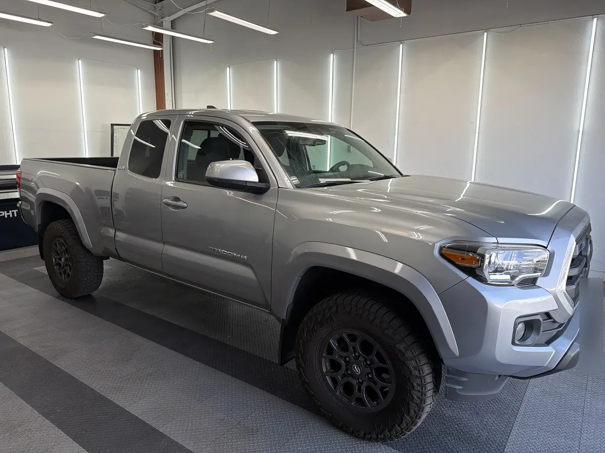 Silver Toyota Tacoma before window tinting, factory glass (view 1)