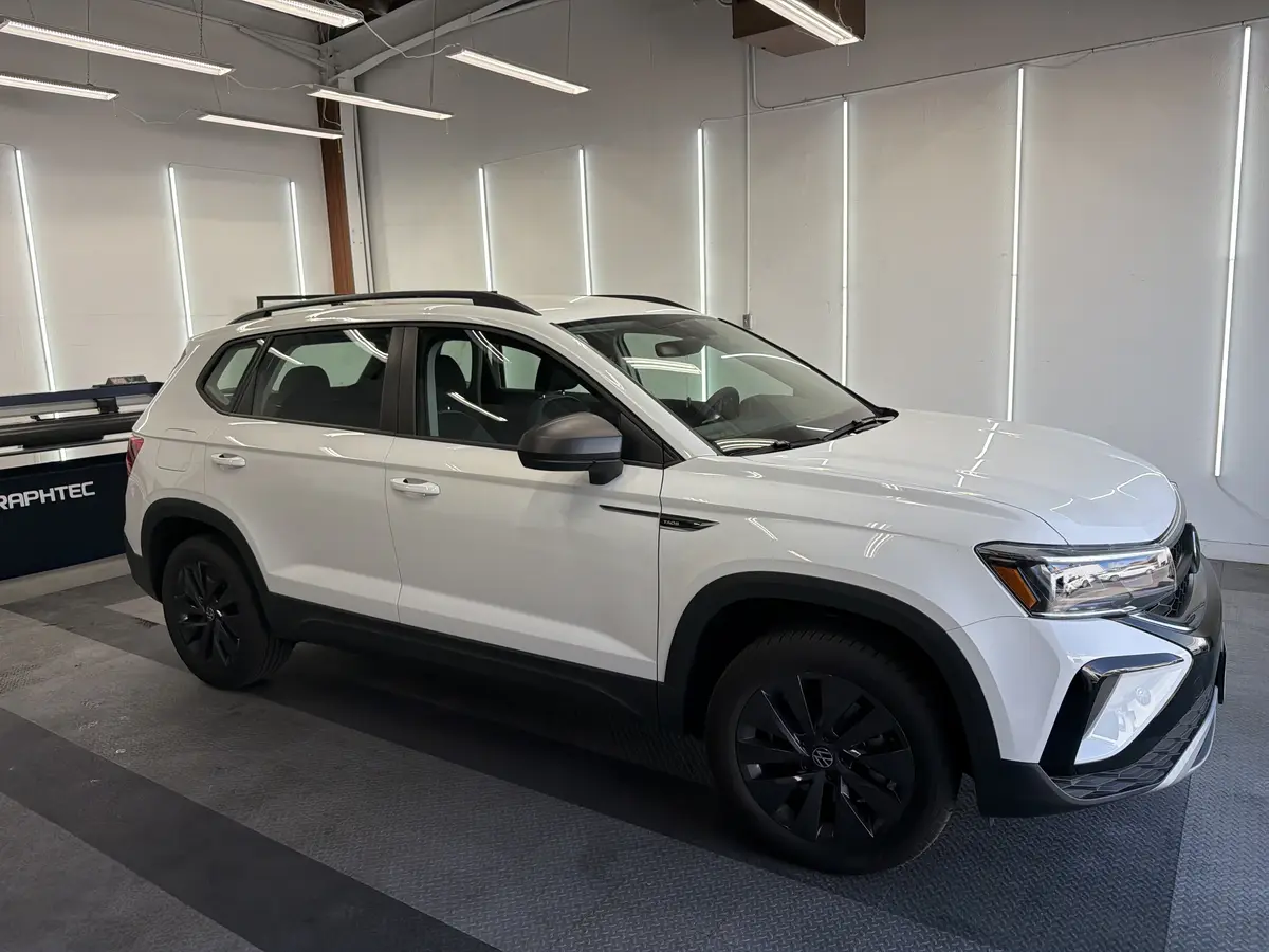 White Volkswagen Taos before window tinting, factory glass (view 1)