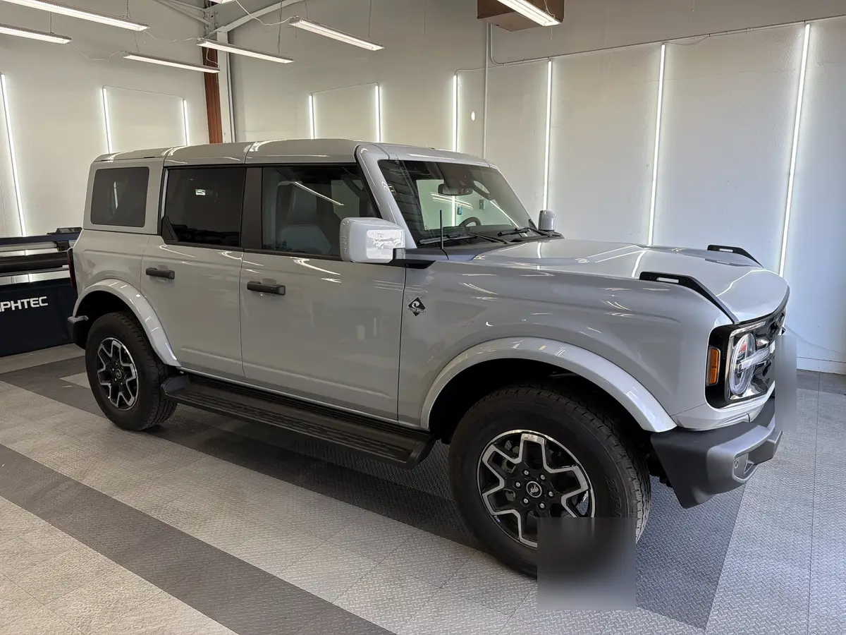 Gray Ford Bronco before window tinting, factory glass (view 1)