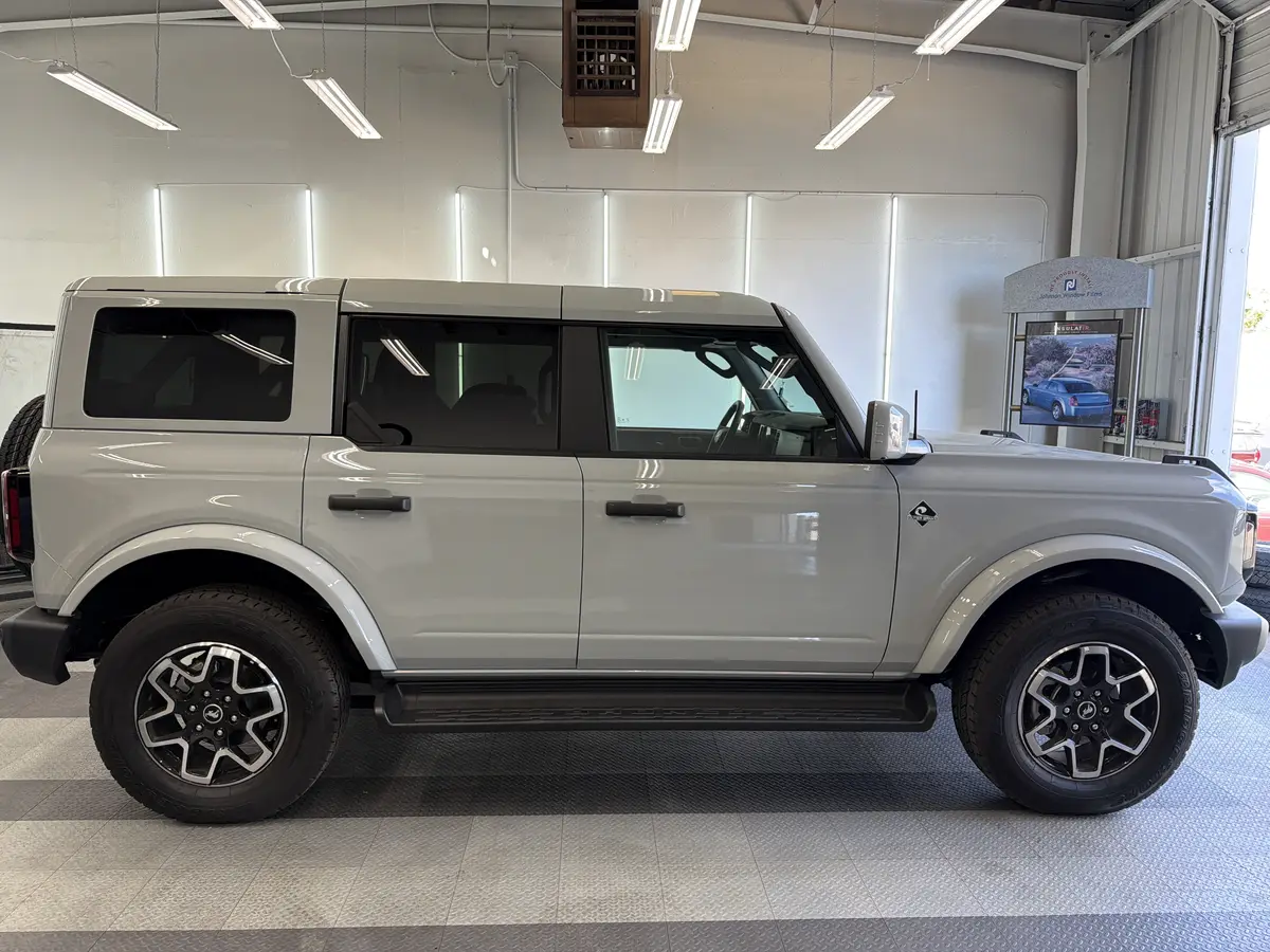 Gray Ford Bronco before window tinting, factory glass (view 2)