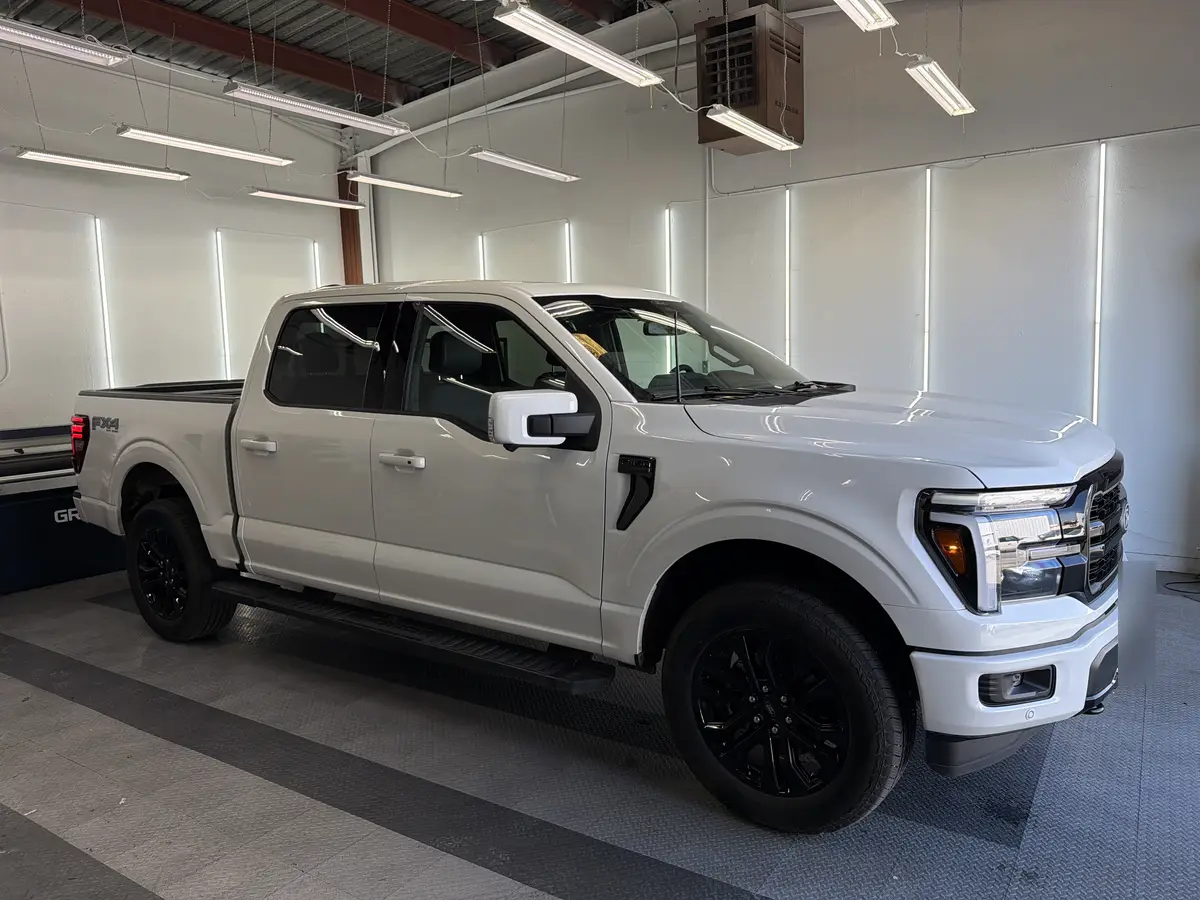 White Ford F-150 before window tinting, factory glass (view 1)