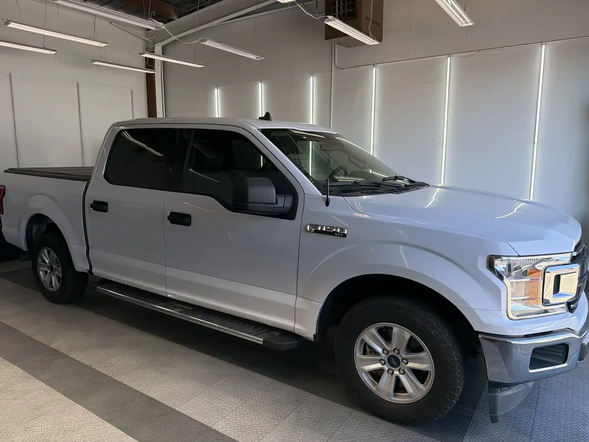 Silver Ford F-150 before window tinting, factory glass (view 1)
