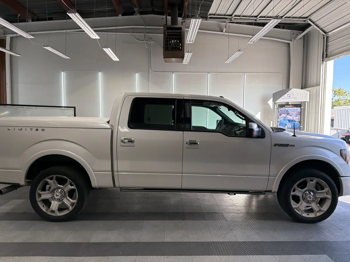 White Ford F-150 before window tinting, factory glass (view 2)