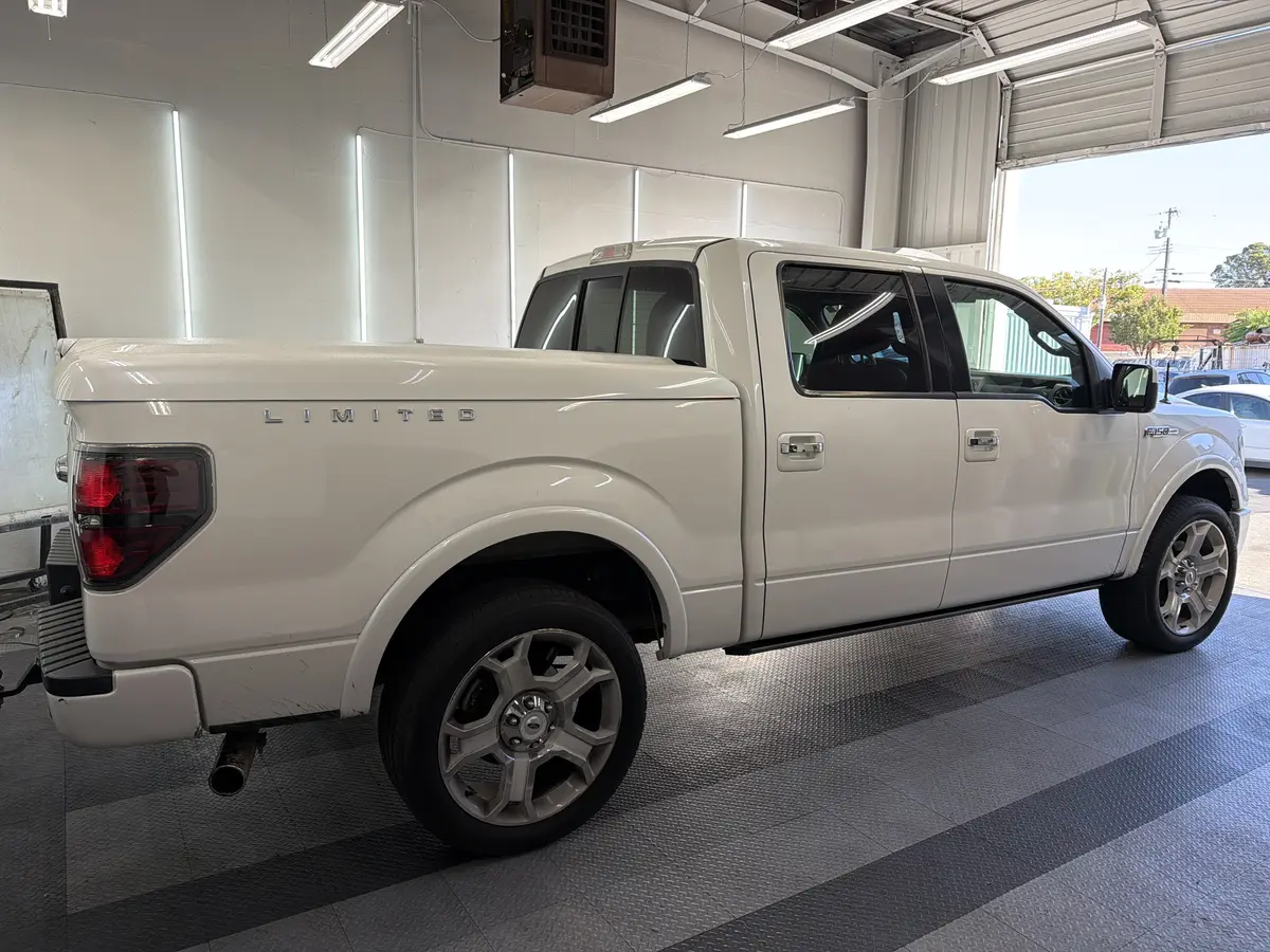 White Ford F-150 before window tinting, factory glass (view 3)