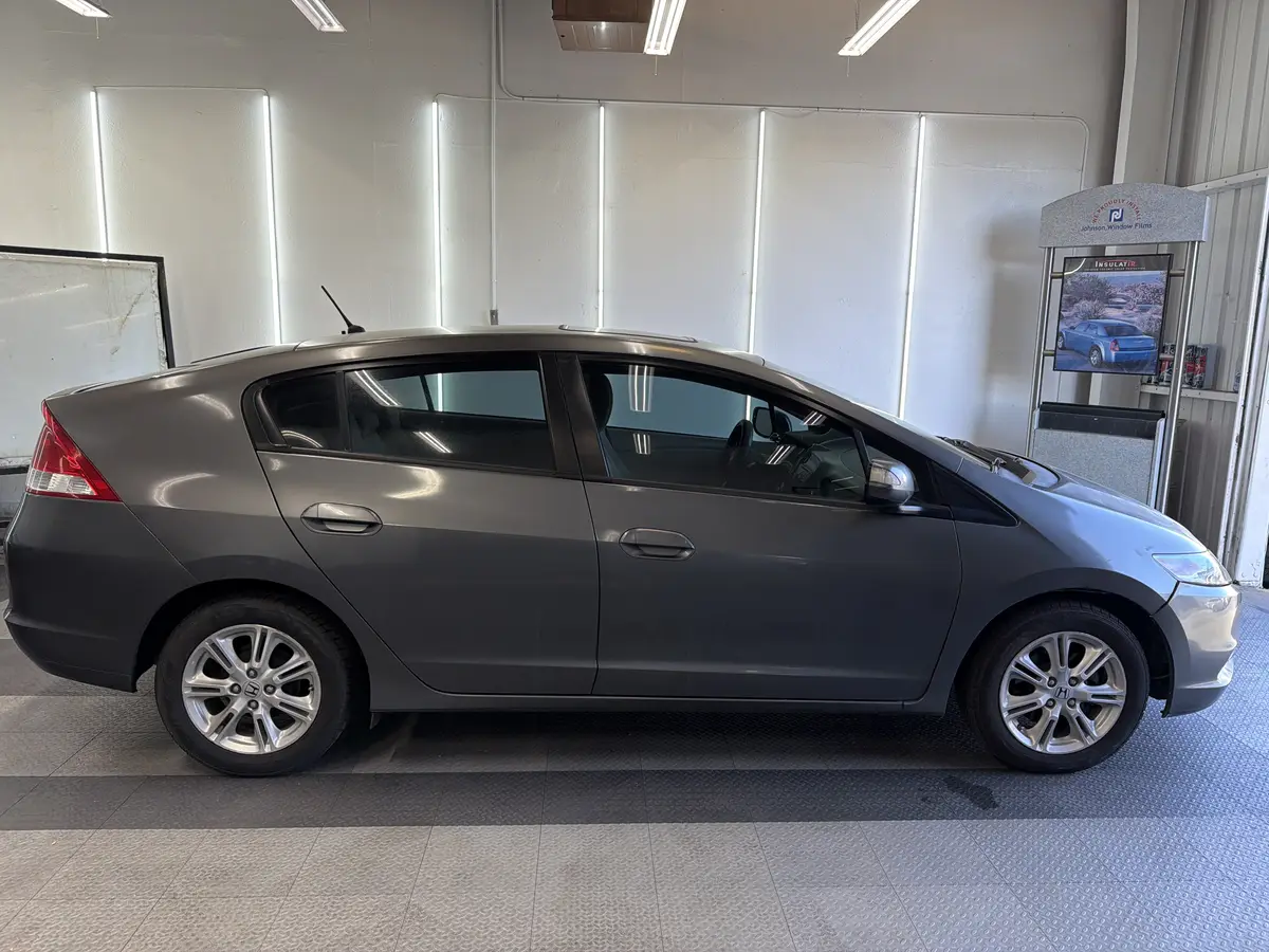 Gray Honda Insight before window tinting, factory glass (view 2)